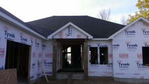 Looking through the front door opening, Lake side windows are being installed first.