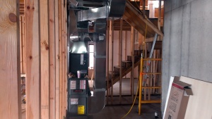 Mechanical work continues inside the home. Furnace and ductwork are installed.