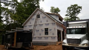 Continuing exterior trim work and windows. Insulation truck on the right. 