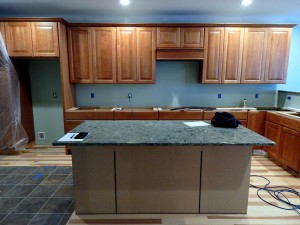 Quartz island and bar tops are installed.